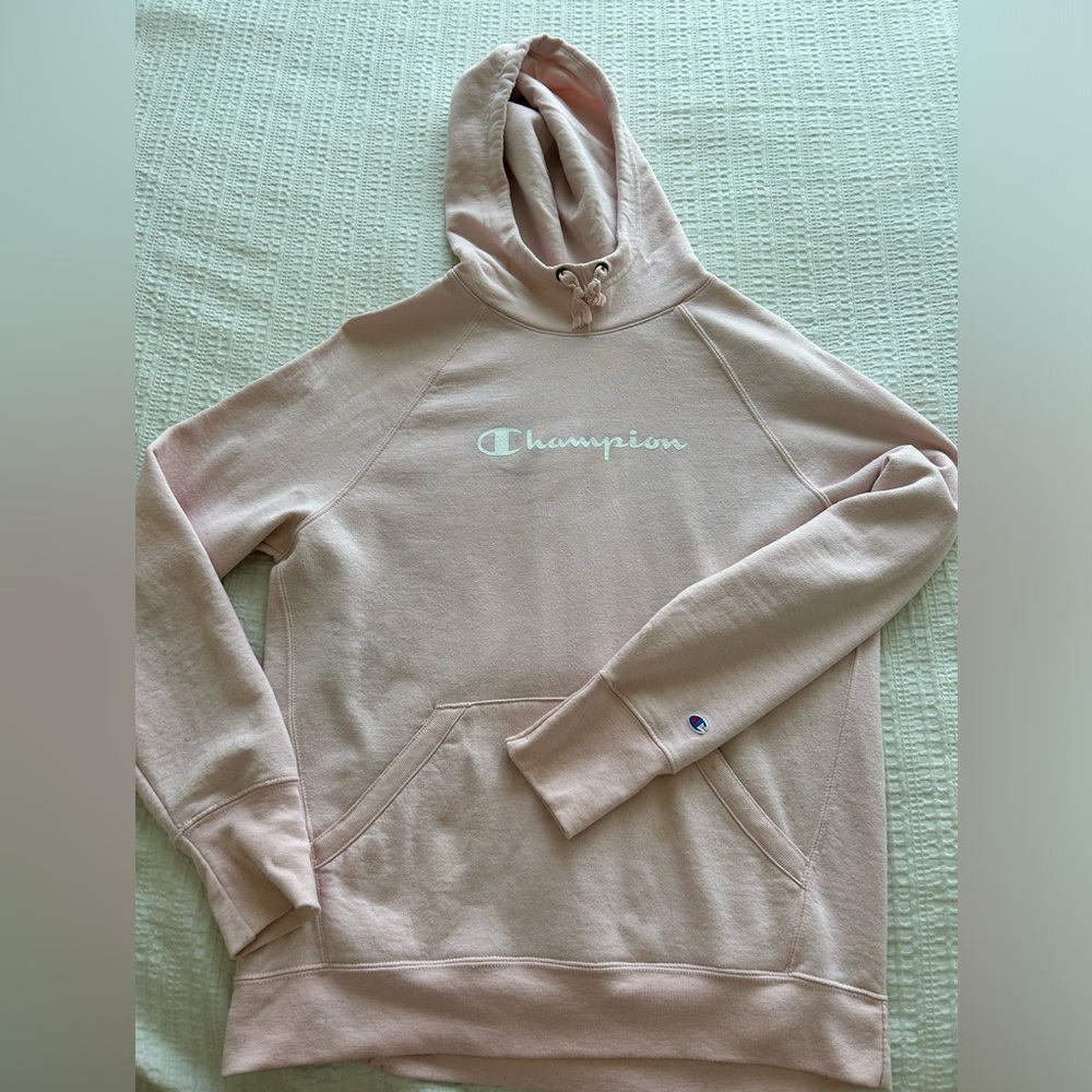 Champion hoodie in size medium in the colour baby pink.